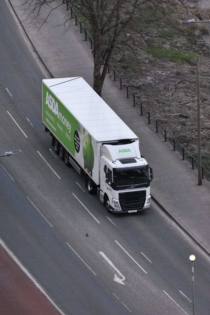 Home High angle view of an ASDA delivery truck driving on an urban street.
